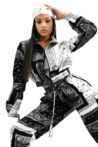 Model wearing black and white paisley bandana print tracksuit women two piece zip jacket and drawstring pants