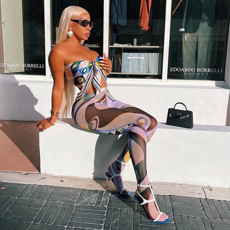 Model wearing aesthetic patterned leggings for women with a colorful abstract design and stylish accessories