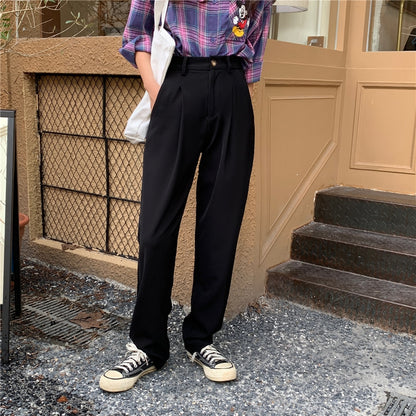 Model wearing Formal straight leg suit office trousers for women. Black trousers paired with sneakers