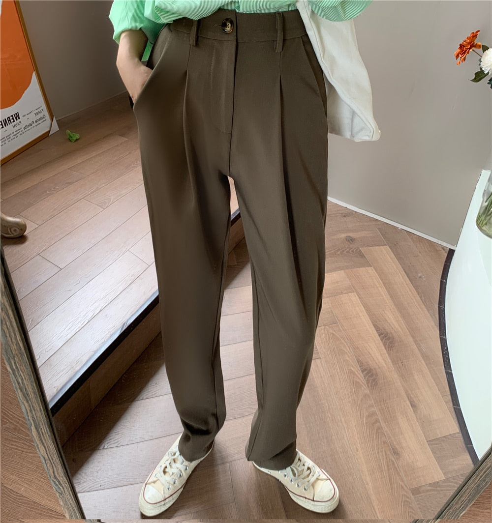 Model wearing olive brown Formal straight leg suit office trousers for women. Pleated high waist and side pockets