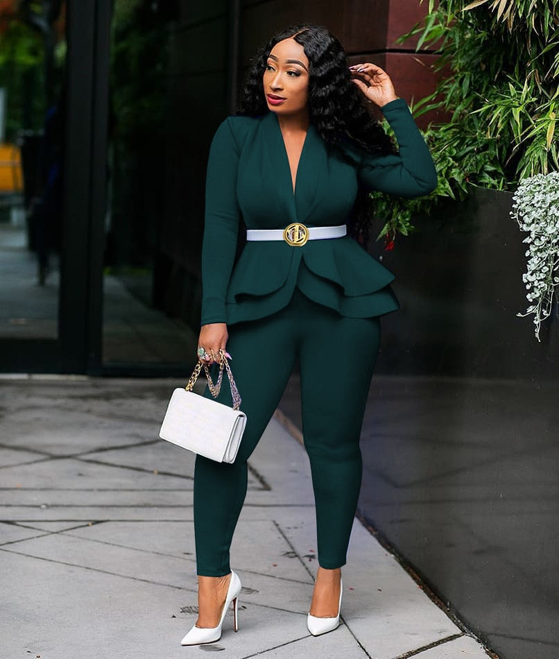 Model wearing emerald green women ruffle blazer pants set with white belt gold buckle handbag and heels