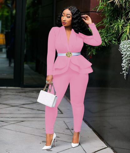 Model wearing pink women ruffle blazer pants set with peplum belt white heels and handbag outdoor