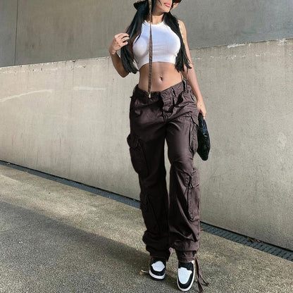 Model wearing EtherealBe women's low waist cargo jeans in dark brown with white crop top and sneakers