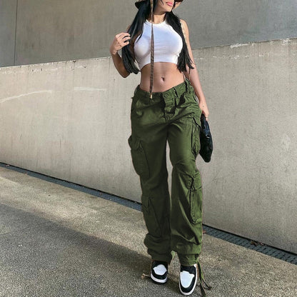 Model wearing olive green women's low waist cargo jeans with utility pockets tapered legs and drawstring ankles