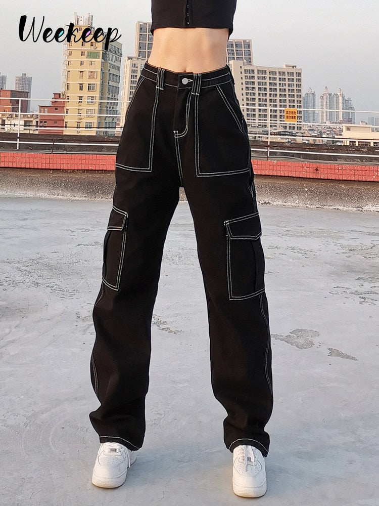 Black high waist baggy cargo jeans for women with white contrast stitching and large cargo pockets on model