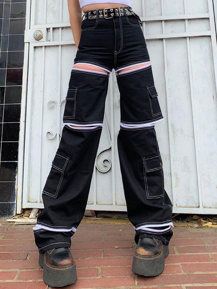 Black high waist baggy cargo jeans for women with pink and white stripe cutouts cargo pockets and platform shoe streetwear look