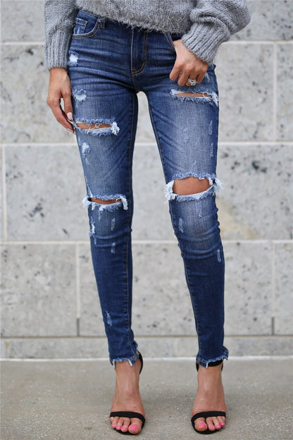 Woman wearing boyfriend ripped jeans for women dark wash with knee and thigh rips frayed hems and heels