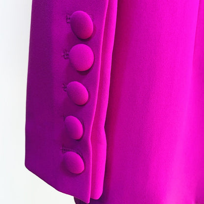 Close-up of a stylish women's purple blazer and pants suit featuring elegant button details