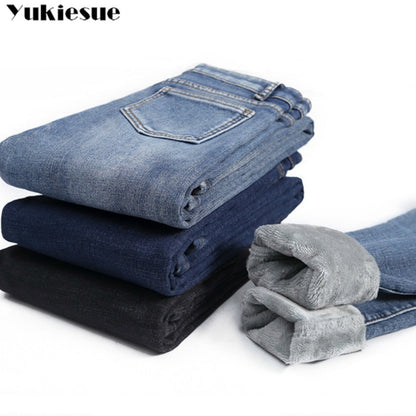 Stack of blue black denim with rolled cuffs showing soft gray fleece lining fleece lined skinny jeans for women