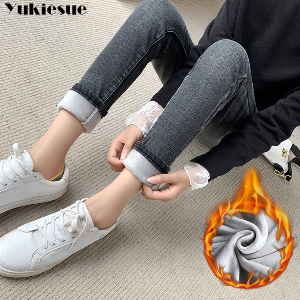 Woman wearing gray fleece lined skinny jeans for women rolled cuff showing soft lining with white sneakers