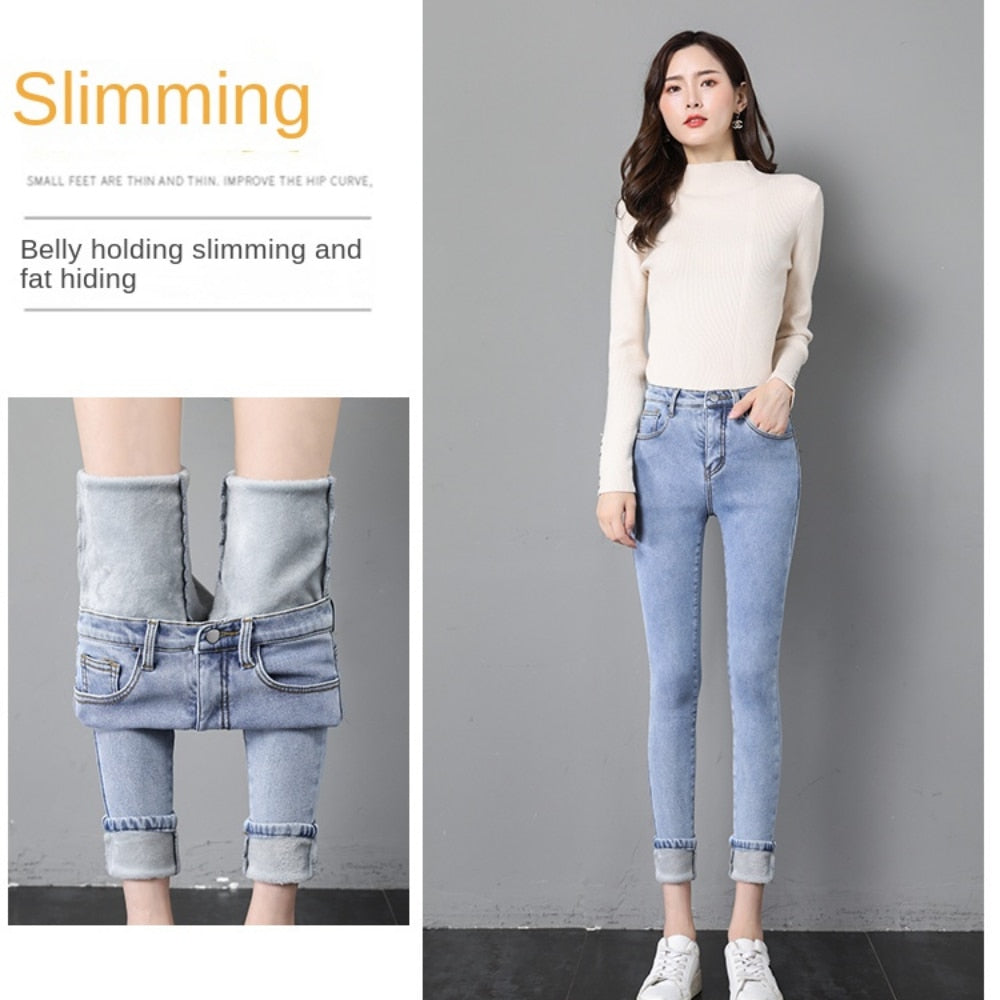 Model wearing light blue high waist fleece lined skinny jeans for women with rolled cuffs and hidden warm lining