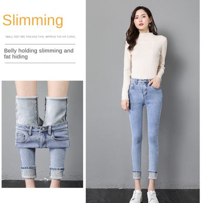 Model wearing light blue high waist fleece lined skinny jeans for women with rolled cuffs and hidden warm lining